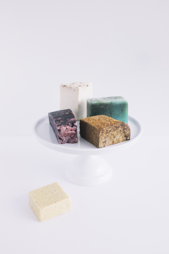 Colorful soap bars on cake stand over white background Colorful soap bars on cake stand over white background