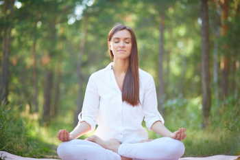 Concentrated woman meditating in nature Concentrated woman meditating in nature