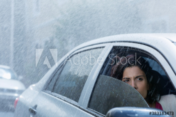 Concerned woman driving car in rain Concerned woman driving car in rain