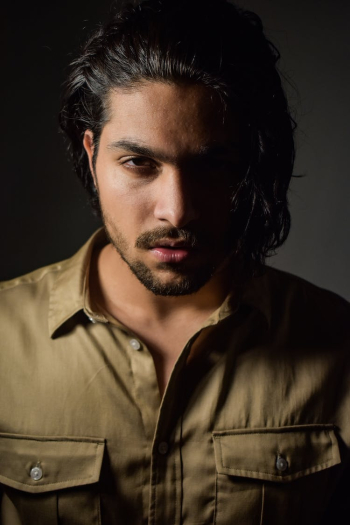 Confident young ethnic male model looking at camera Confident young ethnic male model looking at camera