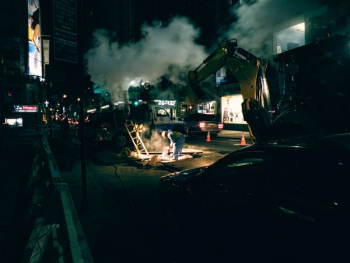 construction workers and vehicles on road during nighttime construction workers and vehicles on road during nighttime
