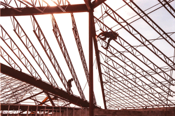 Construction workers are silhouetted against .. | Free public domain photo - 441530