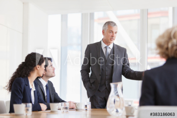 Corporate businessman leading conference room meeting Corporate businessman leading conference room meeting