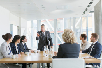 Corporate businessman leading conference room meeting Corporate businessman leading conference room meeting