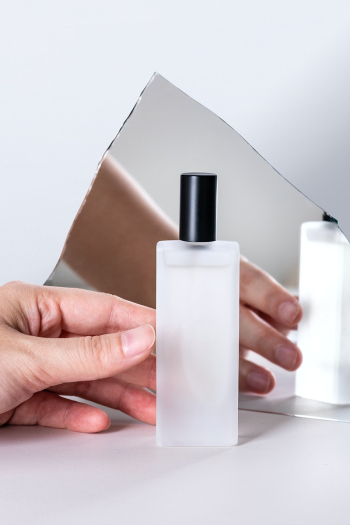 Cosmetic bottle mockup psd held by hand in… | Free stock illustration | High Resolution graphic