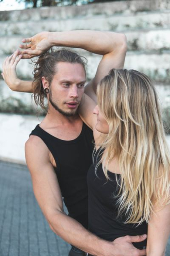 couple in black tank top hugging each other