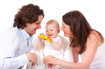 Couple Playing With Their Baby Couple Playing With Their Baby