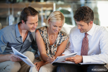 Couple signing paperwork for financial advisor Couple signing paperwork for financial advisor