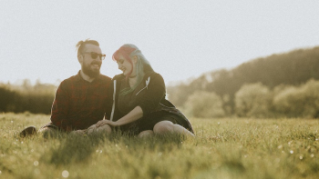 Couple sitting together on the field | Free Photo - rawpixel