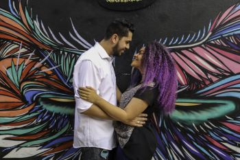 Couple Smiling Near Wall Art Work Couple Smiling Near Wall Art Work