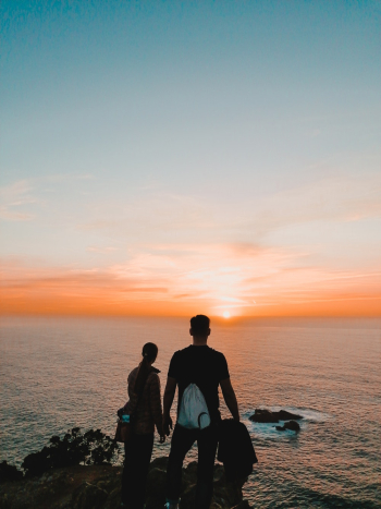 Couple Standing in Front of Sea during Golden Hour Couple Standing in Front of Sea during Golden Hour