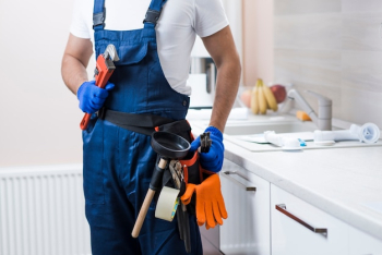 Crop plumber on kitchen Crop plumber on kitchen