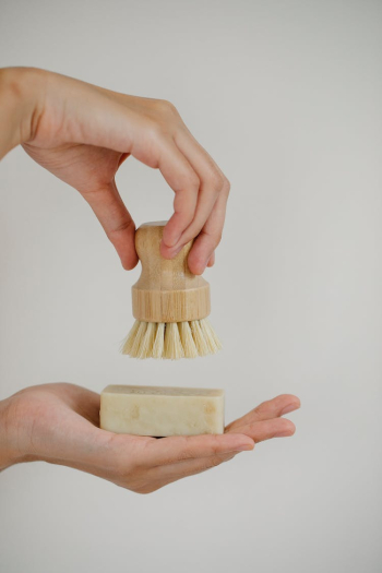 Crop woman with skin care brush and soap bar Crop woman with skin care brush and soap bar