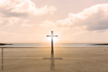 Cross religion symbol shape over sunset sky at the beach Cross religion symbol shape over sunset sky at the beach