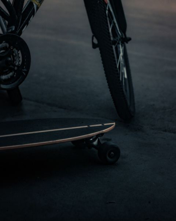 cruiser board beside bicycle cruiser board beside bicycle