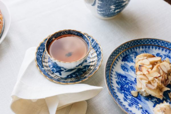 cup filled with brown liquid near plate cup filled with brown liquid near plate