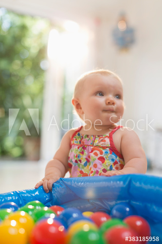 Cute baby girl playing with colorful balls Cute baby girl playing with colorful balls