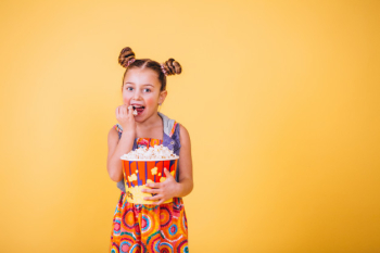 Cute girl eating popcorn Cute girl eating popcorn