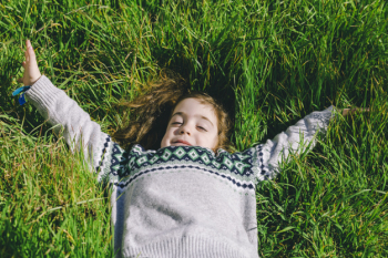 Cute girl lying on grass Cute girl lying on grass