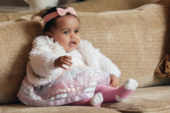 Cute Happy Baby Girl On A Couch Cute Happy Baby Girl On A Couch