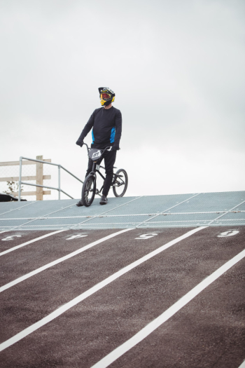 Cyclist standing with bmx bike at starting ramp Free Photo