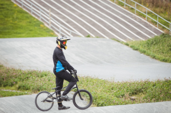 Cyclist standing with bmx bike Free Photo