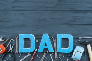 Dad inscription with tools and toy car on table Dad inscription with tools and toy car on table