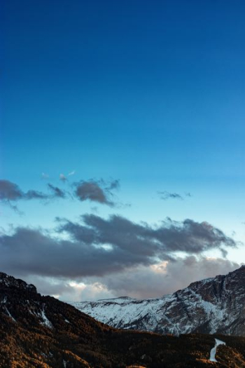 dark clouds over snow capped mountains dark clouds over snow capped mountains