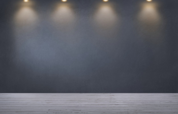 Dark gray wall with a row of spotlights in an empty room Dark gray wall with a row of spotlights in an empty room