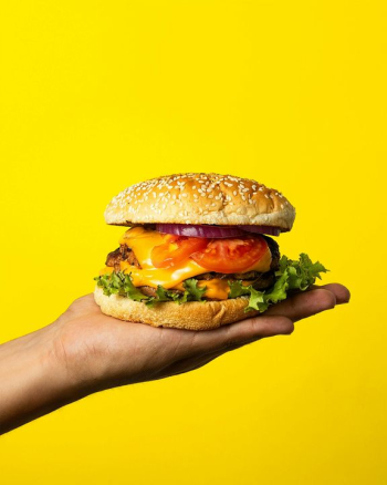 Delicious Cheeseburger on a Hand Delicious Cheeseburger on a Hand