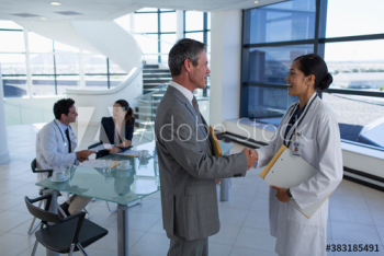 Doctor and hospital administrator shaking hands Doctor and hospital administrator shaking hands