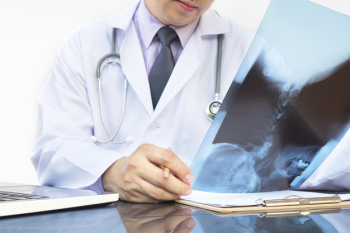 Doctor examine x-ray film over white background Doctor examine x-ray film over white background