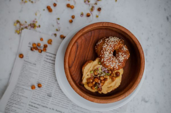 doughnut in round brown wooden tray doughnut in round brown wooden tray