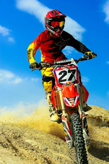 Dynamic Motocross Rider Soaring Through Dusty Terrain Dynamic Motocross Rider Soaring Through Dusty Terrain