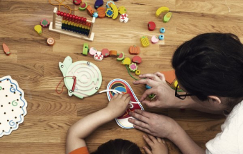 Early Childhood Educator With Toys And Child Early Childhood Educator With Toys And Child