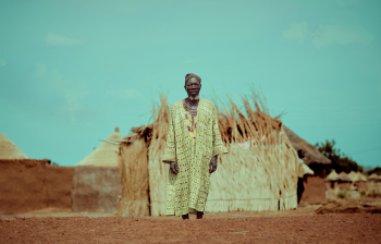 Elderly Man Standing Near Structure Elderly Man Standing Near Structure