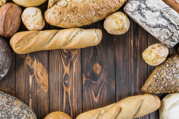 Elevated view of bread loves on dark wooden background Elevated view of bread loves on dark wooden background