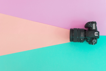 Elevated view of professional camera on colored background Elevated view of professional camera on colored background