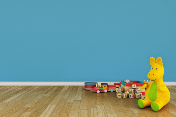 Empty children room with toys on hardwood floor.