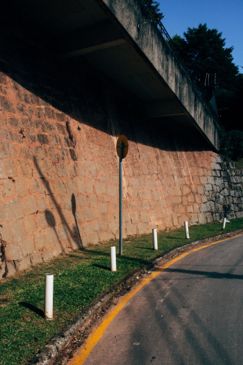 Empty Concrete Road Near Brick Wall Empty Concrete Road Near Brick Wall