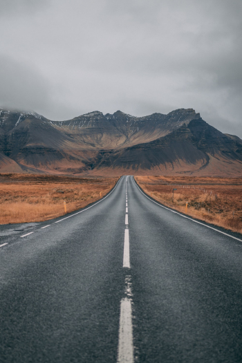 Empty Highway Overlooking Mountain Under Dark Skies Empty Highway Overlooking Mountain Under Dark Skies