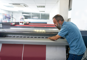 Espertise man in transfer printing industry plotter printer hipster beard