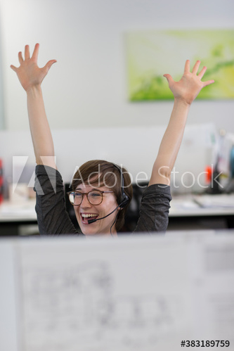 Excited businesswoman celebrating in office Excited businesswoman celebrating in office