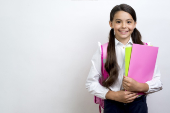 Excited hispanic schoolgirl carrying copybooks Free Photo Excited hispanic schoolgirl carrying copybooks Free Photo