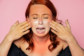 Face mask tan line on an upset woman's face Face mask tan line on an upset woman's face