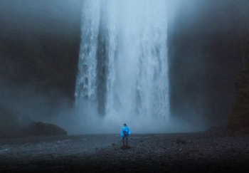 face standing in front of water falls face standing in front of water falls