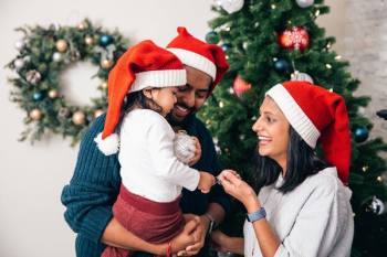 Family Of Three Decorates Christmas Tree Family Of Three Decorates Christmas Tree