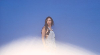 Fashion Model On Blue Wall With Lens Flair Fashion Model On Blue Wall With Lens Flair