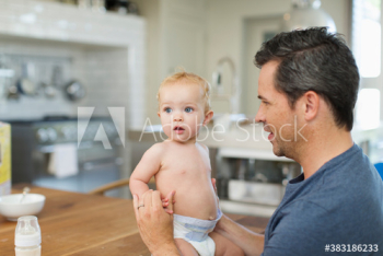 Father and cute baby son at dining table Father and cute baby son at dining table