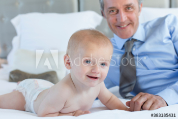 Father and cute baby son on bed Father and cute baby son on bed